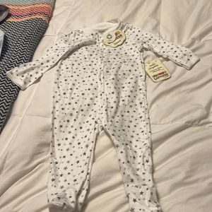 Lamaze zip footie white background with starts. Item is new with tags 9m